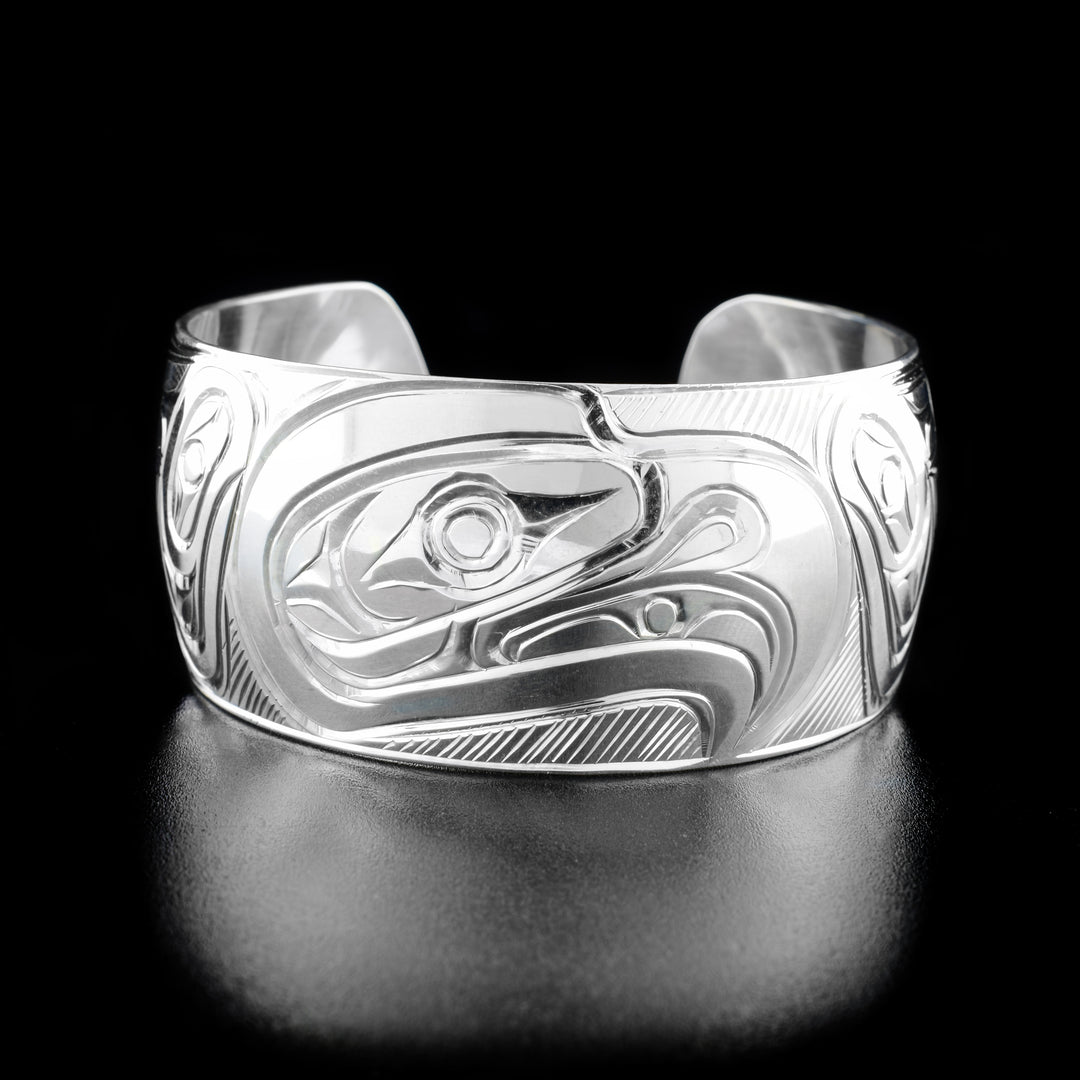 This Eagle bracelet is made from sterling silver and have a single, wide band with a gap in the back. There is a depiction of the Eagle that has been hand crafted into the surface of this cuff bracelet.