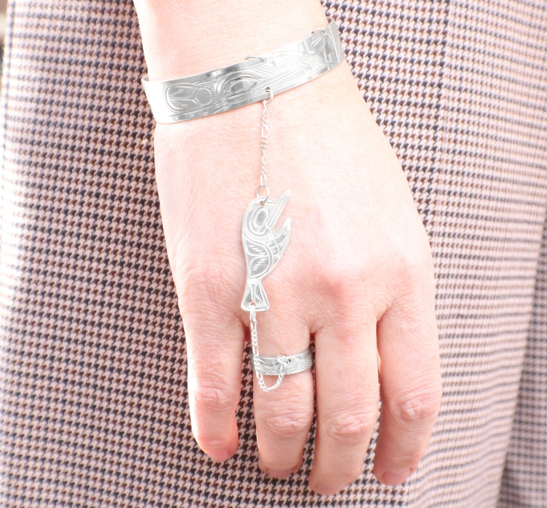 Hummingbird hand chain on a female wrist.