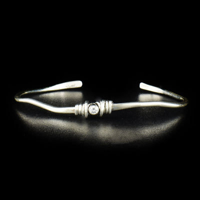 Sterling Silver Coil with Cubic Zirconia Cuff Bracelet handcrafted by artist Joy Annett made using sterling silver with a cubic zirconia accent in the center of the bracelet.