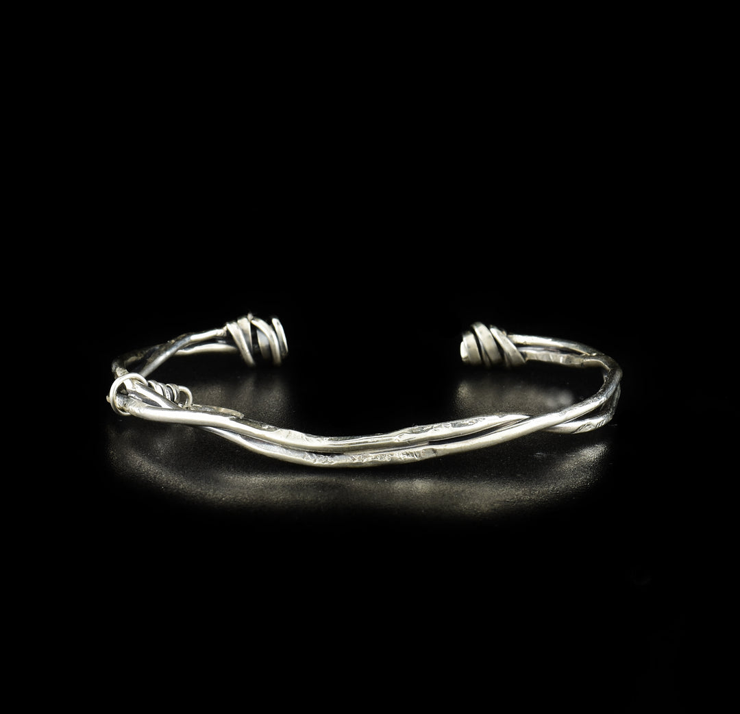 This sterling silver coil bracelet cuff is made from two wide wires that are twisted together and "tied off" at the ends.