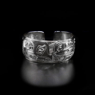 This 1" Eagle and Orca Bracelet is hand carved by Heiltsuk artist Ivan Wilson. He has used sterling silver to create this piece. The bracelet measures 6.5" in length, 1.0" in width, and has a 0.5" gap. The Eagle Legend Represents: POWER, INTELLIGENCE, VISION. The Orca Legend Represents: LONGEVITY, PROTECTION, FAMILY.