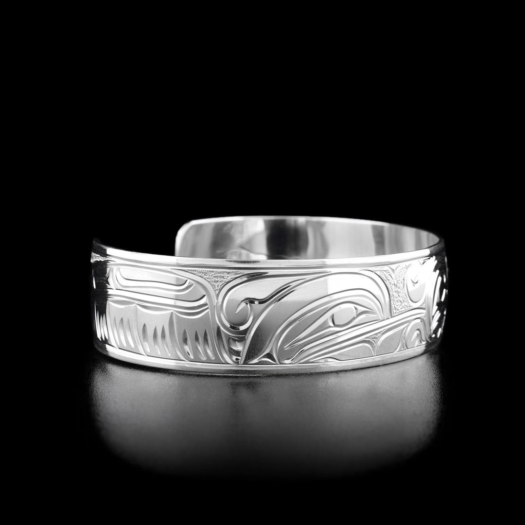 Left angle photo of the bracelet shows carved designs representing the wing of one of the hummingbirds. Other side of the bracelet is identical.