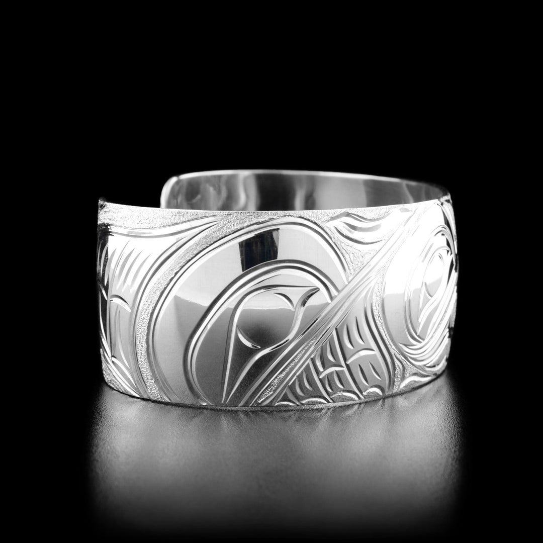 Left angle photo of the bracelet shows another hummingbird's head facing towards the center with a spread wing behind it.