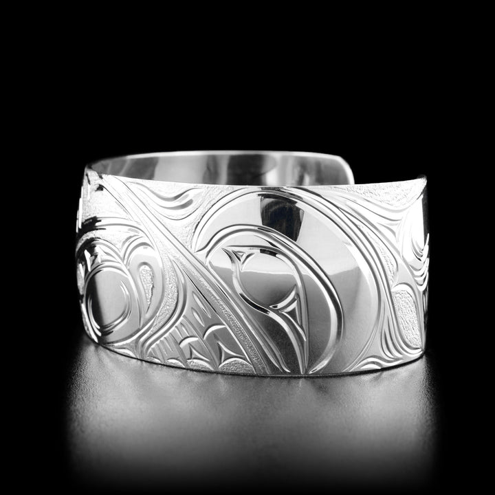 Right angle photo of the bracelet shows a third hummingbird's head facing towards the center with a spread wing behind it.