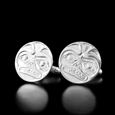 Sterling Silver Bear Cast Cufflinks by Carrie Matilpi. The design of each cufflinks depicts a bear looking forward. The bear has two round ears at the top of the cufflinks; two, wide eyes looking forward; a short snout, and an open mouth with sharp teeth.