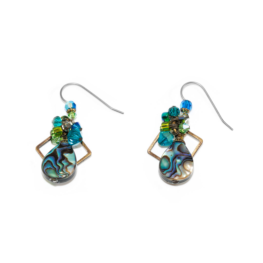 These dazzling crystal drop earrings have been made using  hand worked brass, Swarovski crystal, pressed glass, and genuine abalone. There are two circle shaped abalone gems dropping down from the hooks with bead clusters made form crystals and glass beads. There are squares behind the piece made from brass wires.
