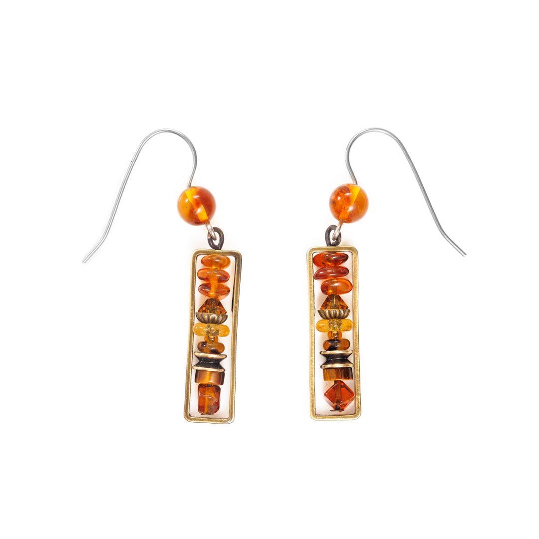 These beaded crystal earrings are made using  hand worked brass, Austrian crystal, Baltic amber, tiger's eye, and glass. There is a length of small beads made from the crystals and gems that are framed by a long, brass rectangle. 