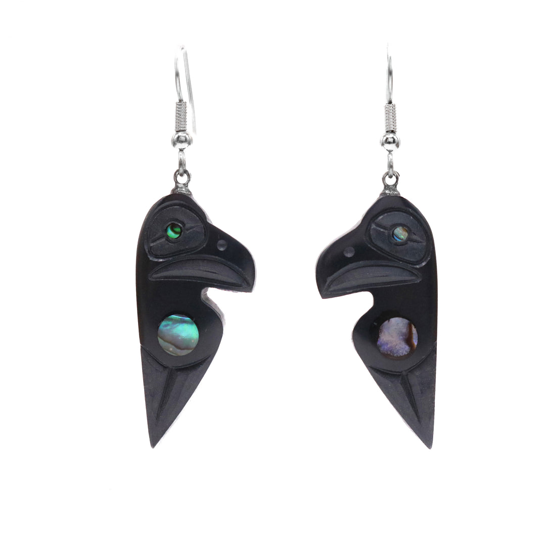 These argillite stone and abalone earrings have chunky argillite hangs that have been carved to depict the Raven. The Ravens head is by the hangs and is has a wing depicted below it. There is abalone set by the wing and in the eye. 