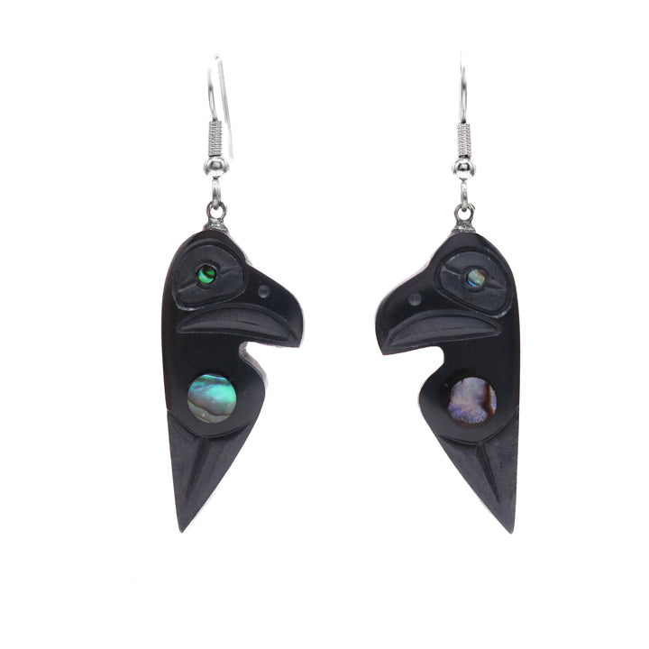These argillite stone and abalone earrings have chunky argillite hangs that have been carved to depict the Raven. The Ravens head is by the hangs and is has a wing depicted below it. There is abalone set by the wing and in the eye. 