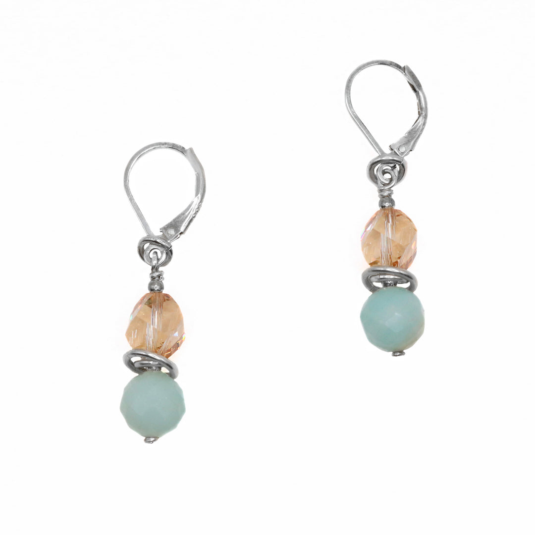 These amazonite earrings are made using tan Swarovski crystals, amazonite gems and sterling silver. The hangs consists of a crystal and a gem that are held using the silver wires.