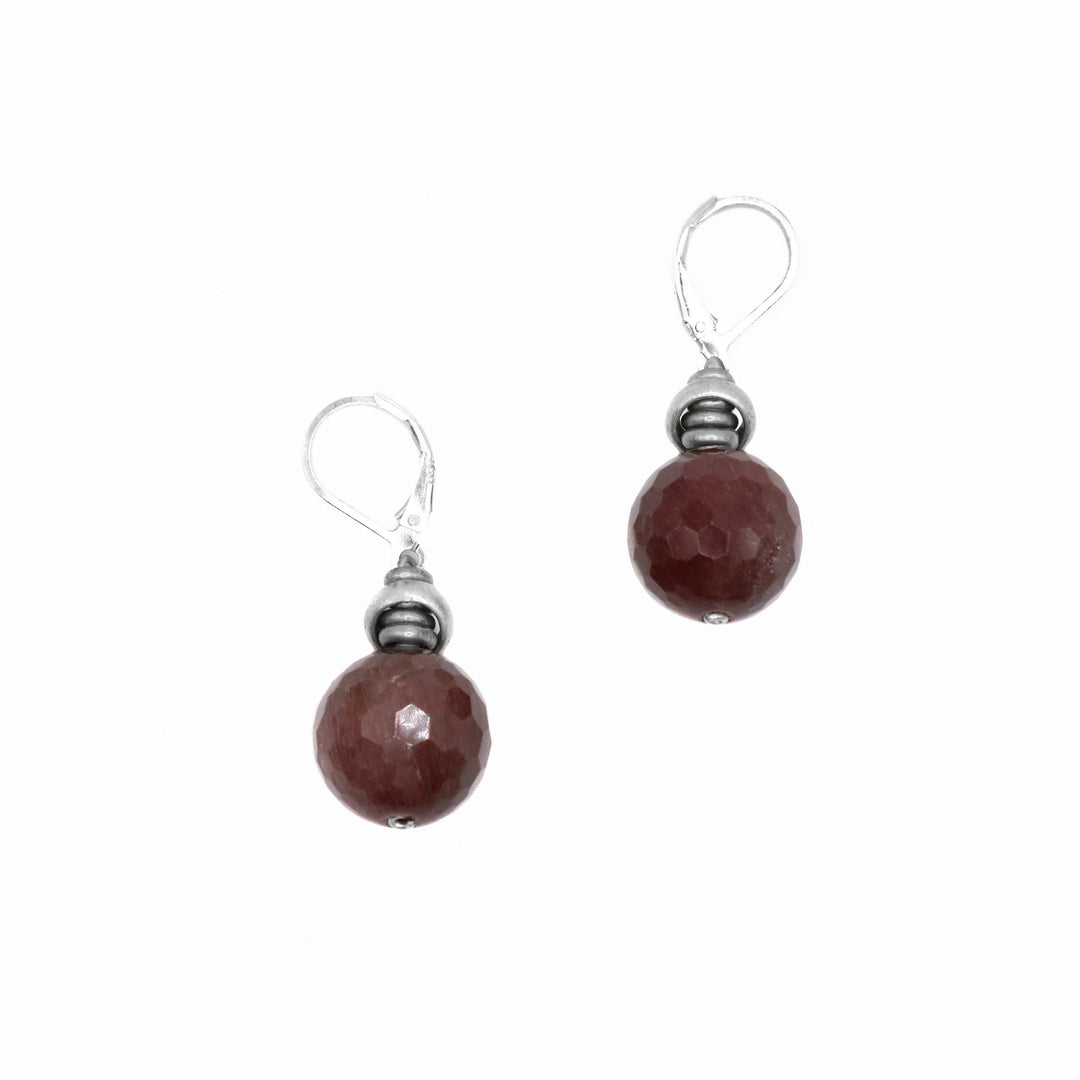 These rutilated quartz earrings are made using faceted silver and sterling silver hooks. There are faceted silver charms with beautifully cut quartz spheres dangling from them.
