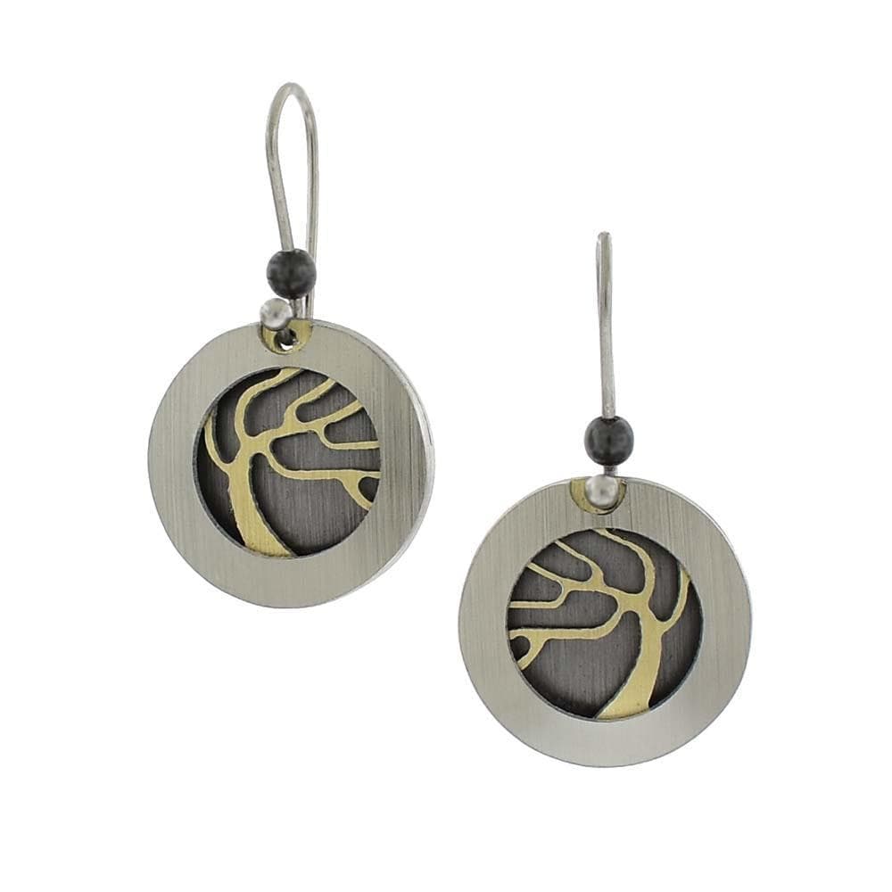 These aluminum earrings are made with aluminum, anodized aluminum and stainless steel. The hangs are circle shaped and there are depictions of trees made from anodized aluminum in the middle of them.