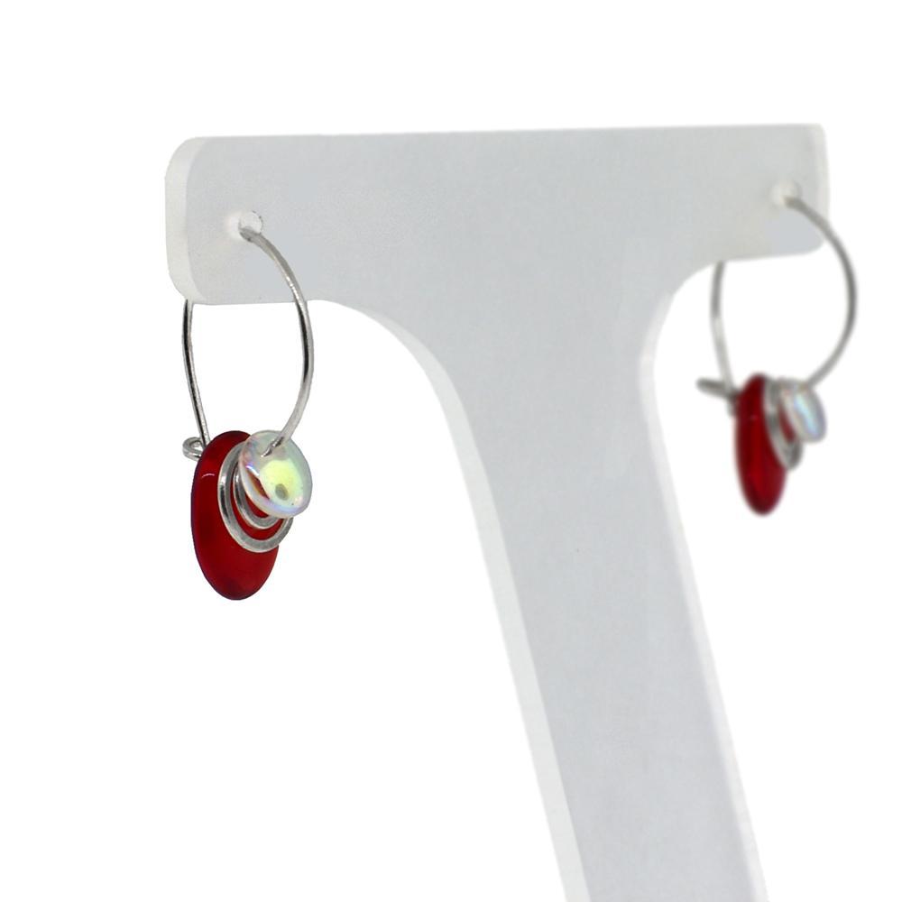 These beaded hoop earrings are made from sterling silver and glass beads. The silver hoops curve below the ear and you can interchangeably add up to three colorful beads to each earring