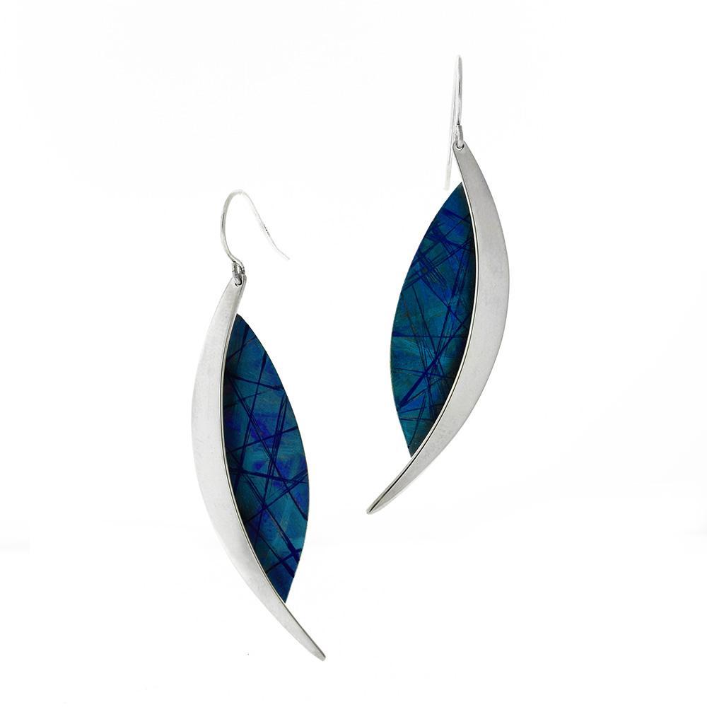 These dangling titanium earrings are made from sterling silver and anodized titanium and have long, oval shaped hangs. Half the hangs are blue and have fancy designs achieved by anodizing titanium and the other half is brilliant silver.