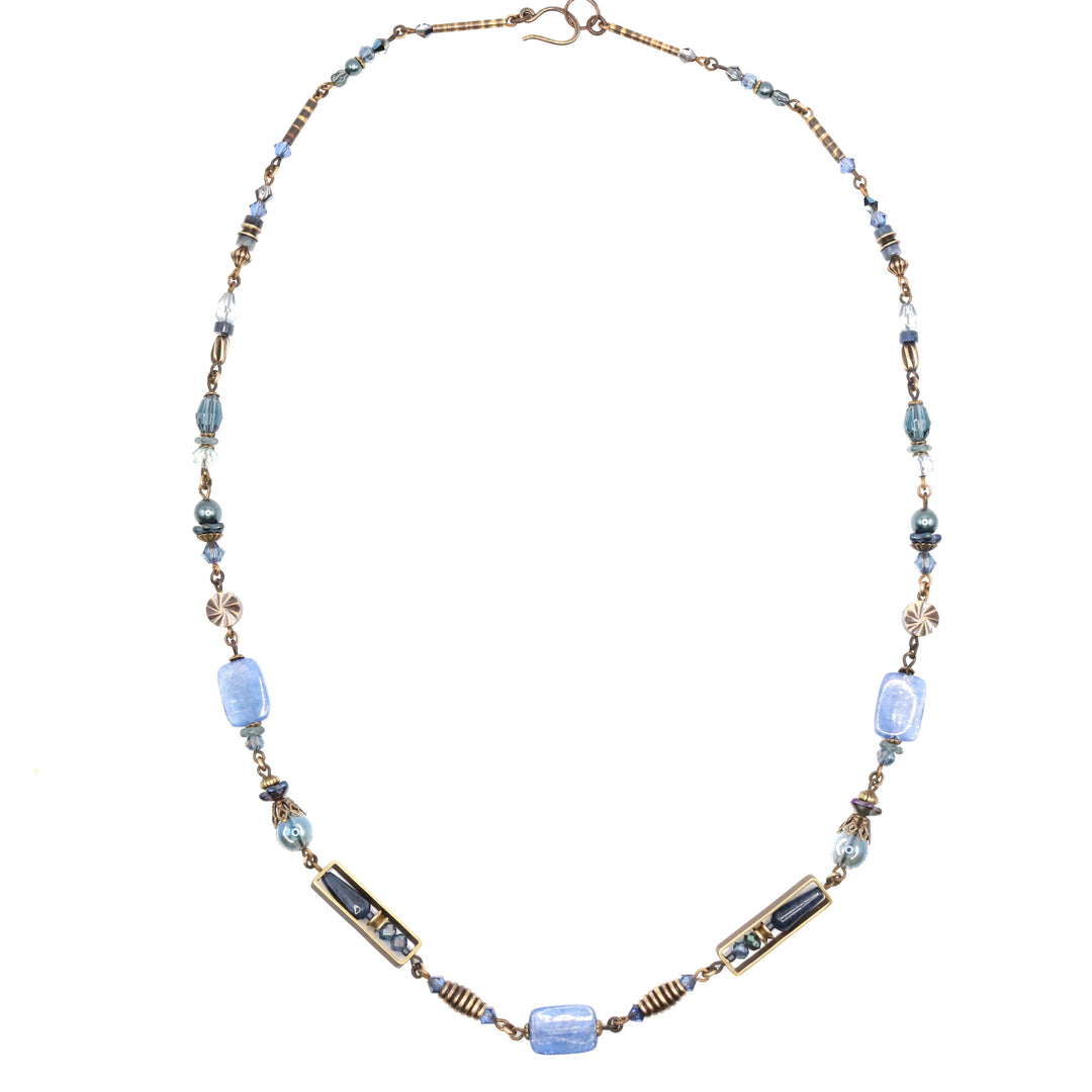 This Austrian crystal necklace is made from Austrian crystal, handworked brass and beads, faceted glass, dumortierite, kyanite, and glass. There are funky and unique beads running along the piece; the beads have unique designs, shapes, sizes and materials.