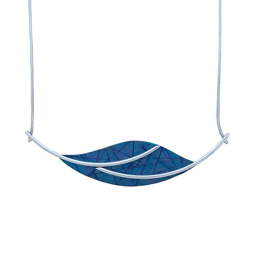This blue titanium necklace is made from sterling silver and anodized titanium. The pendant is a long, horizontal oval that is blue and has designs achieved by anodizing the titanium. There are silver wires extending from both ends of the pendant and curve across the surface of it.