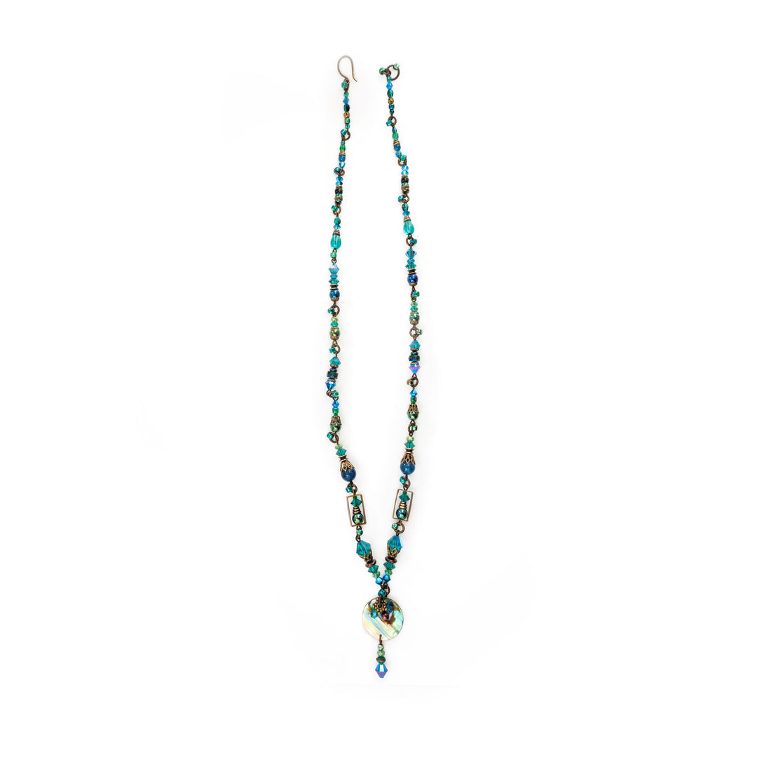 This elegant abalone necklace has dainty apatite, glass, brass and Swarovski crystal beads that are held together using hand worked brass. There is a drop pendant made from a circular abalone piece.
