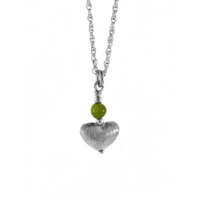 This delicate pendant was made by artist Karley Smith. The little bead of BC Jade rests above a three-dimensional brushed silver heart.  The pendant is 0.5" (1.25cm) tall and the chain is 16″ long with a 2" chain extender.
