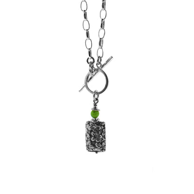 This detailed pendant was made by artist Karley Smith. The three-dimensional silver rectangle below the ball of BC Jade has tiny, delicate flowers carved into it.  The pendant is 0.75" (2cm) tall and the chain is 17" long.