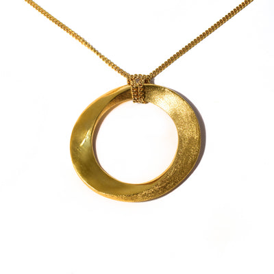 This Gold Plated Infinity Grand Necklace is by artist Pamela Lauz.  Pamela's signature polished and textured finish gives this continuous circle a captivating personality.  The pendant measure 1.6" x 1.75". The 16" gold fill chain is included.