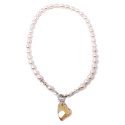 This Crystal and Pearl Sweetheart Necklace is handcrafted by artist Karley Smith. She has used freshwater pearls, Swarovski crystal, and sterling silver to create this piece.  The necklace is 18" long and the pendant measures 1.50" x 0.75", including the toggle clasp.