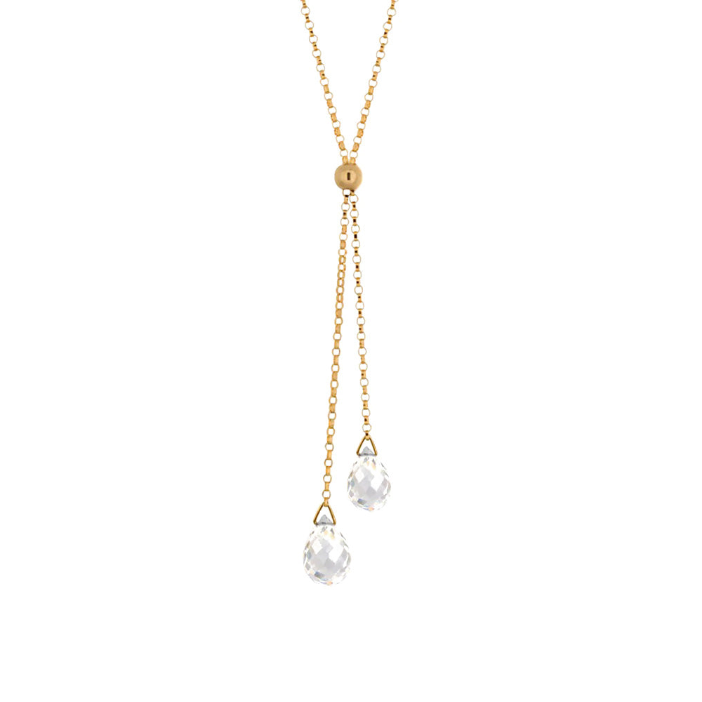 This rock crystal necklace has a dainty 14K gold filled chain and there are two lariats hanging below the necklace. There are two teardrop shaped gems that are lantern hanging at the bottom.