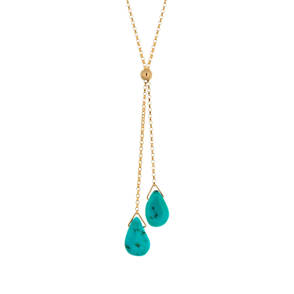 This elegant turquoise necklace is made using 14K gold fill and genuine turquoise gemstones. The gems are teardrop shaped and are displayed from two lariats hanging below the necklace.