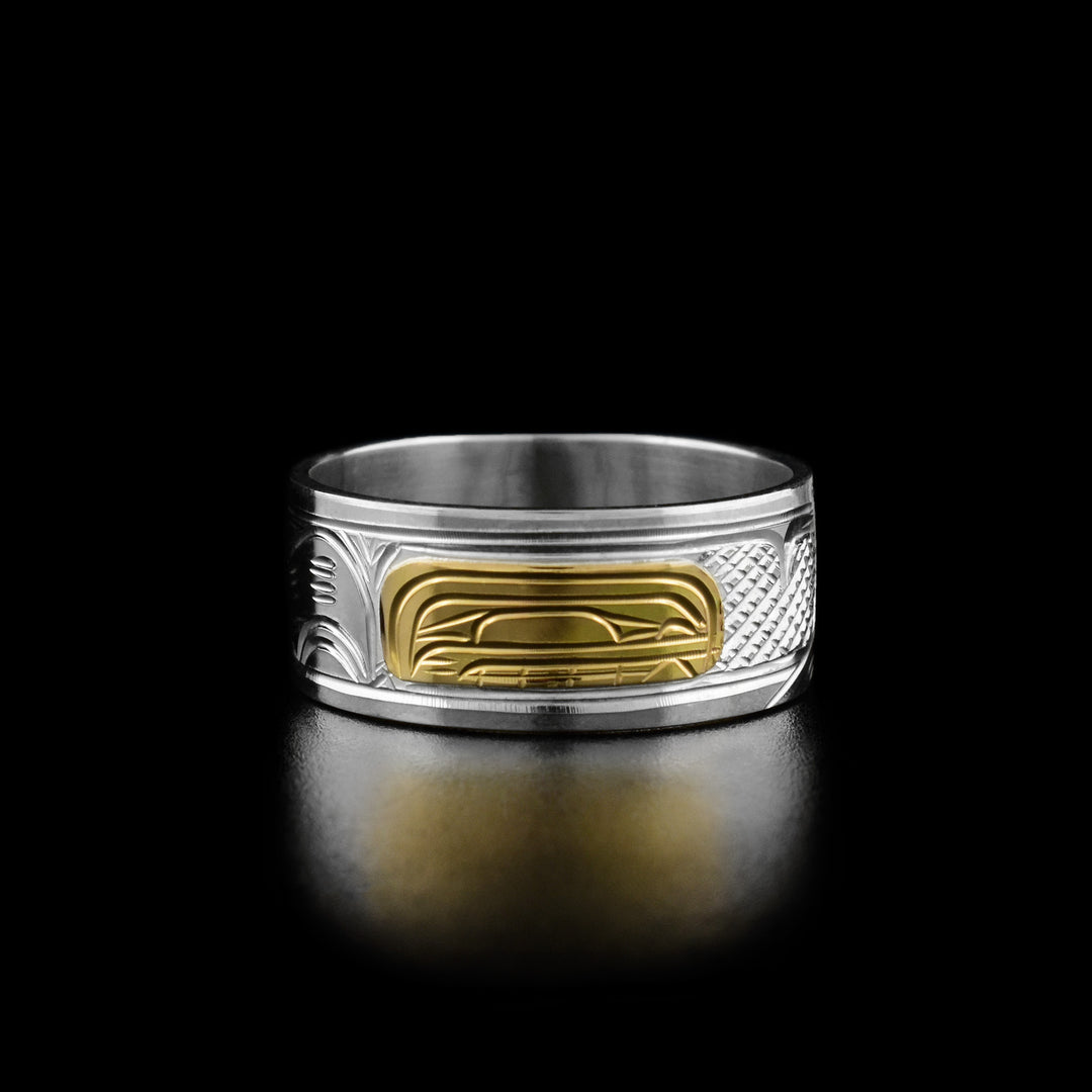 14K Gold and Sterling Silver 3/8" Orca ring by Victoria Harper. The design depicts the profile of an orca's head made from 14k gold facing the right. On both sides of the orca's head the artist has hand carved intricate designs representing the orca's fin and tail using sterling silver.