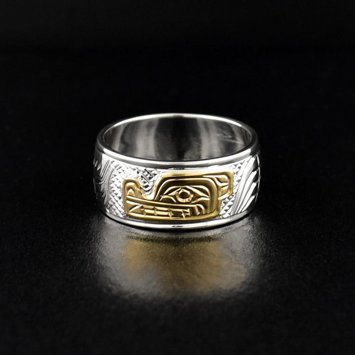 This silver Wolf ring is made from sterling silver and 14K gold and has a single band. There is a depiction of the Wolf carved into the surface of the band and the head of the Wolf is made from 14K gold.