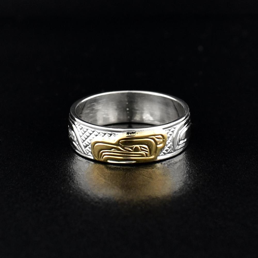 This Eagle ring is made from sterling silver and 14K gold and has a single band. There is a depiction of the Eagle carved into the surface of the band and the head of the Eagle is made from 14K gold.