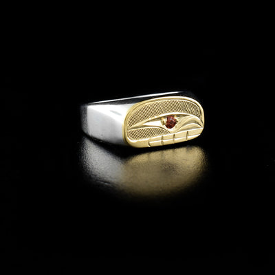 This 14K Gold and Sterling Silver Ovoid Signet Orca Ring with Citrine is hand-carved by Haisla artist, Hollie Bartlett.  Hollie has used 14K gold and crosshatching to depict the face of an orca and has set citrine in the eye. The rest of the ring has been made with sterling silver.  Size 8 available.     ﻿The Orca Legend Represents: ﻿LONGEVITY, PROTECTION, FAMILY.