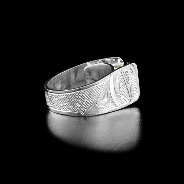 Solitaire Hummingbird Ring with Amethyst by Fred Myra. This second picture shows the same ring as the first photo but from a side view. Here you can see the hand-carved profile of a hummingbird mid-flight facing towards and a neatly hand-carved crisscross pattern for the background.