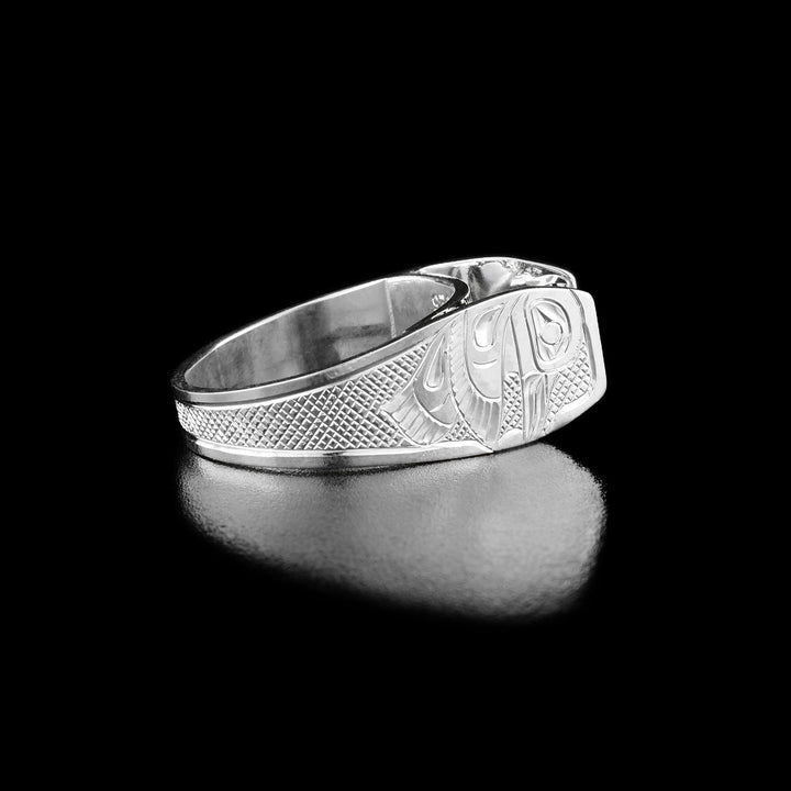 Solitaire Hummingbird Ring with Rhodolite Garnet. This secondary picture shows the same ring as the first picture but at a side view. Here you can see the hand-carved profile of the hummingbird mid-flight facing downward with a crisscross background.