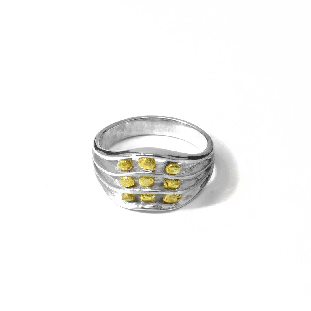 Sterling silver and 22K gold nugget ring by Tom Gregorczyk. The ring divides into 3 different levels at the front with 3 22k gold nuggets on each level. The ring tapers at the back.