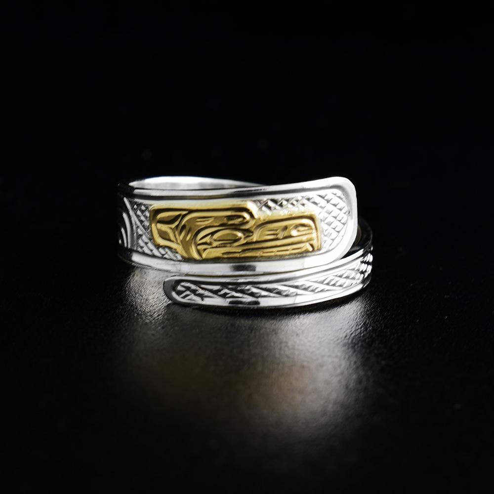This 14K gold and sterling silver wrap ring has a tapered band that wraps around the finger twice. There is a depiction of the Bear carved into the surface of the band. The face of the Bear is made from 14K gold.
