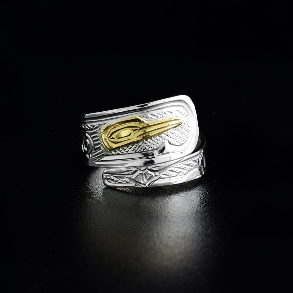 This Hummingbird ring is made from sterling silver and 14K gold. The band is tapered and wraps around the finger twice. There is a depiction of the Hummingbird carved into the surface of the band. The head of the Hummingbird is made from 14K gold.