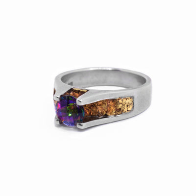 Gold Nugget Topaz Ring by Tom Gregorczyk. The topaz is the focal point in the center of the ring with sterling silver supporting the gemstome. The artist has put 22K gold nuggets underneath the topaz.