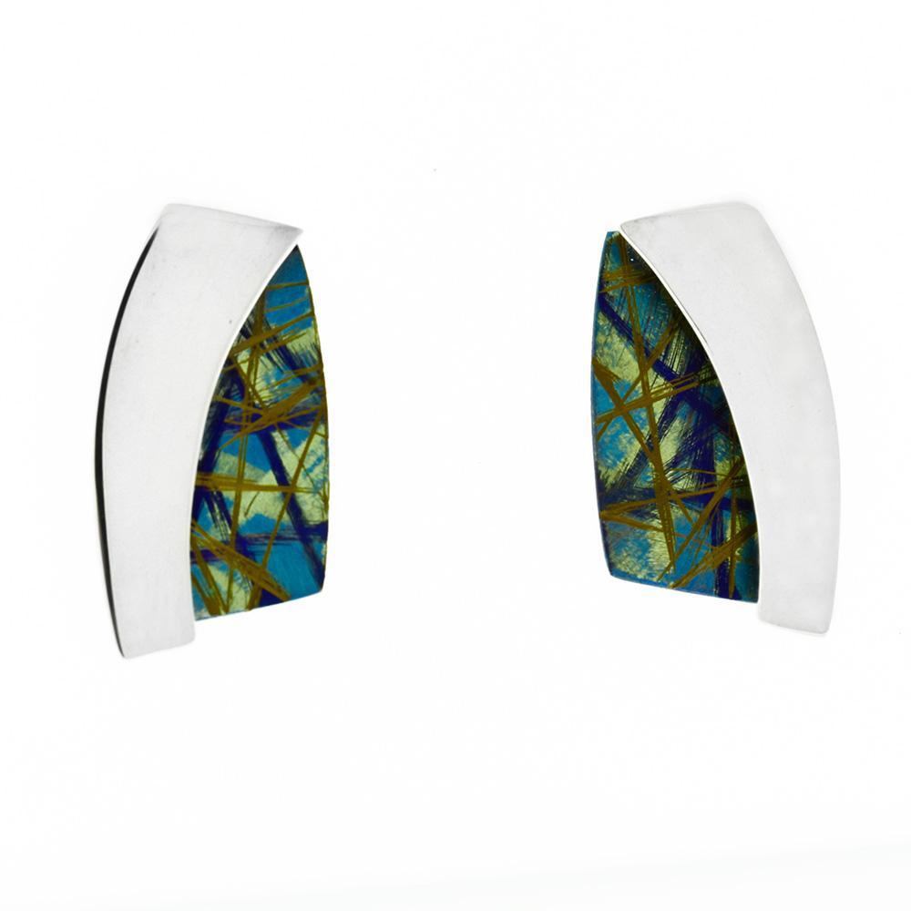 These Sterling silver and anodized titanium earrings have a large, rectangular shaped with one side of them curving like an arch. Half the stud is made from shining silver and the other half from titanium that has been anodized to achieved colorful designs and patterns.