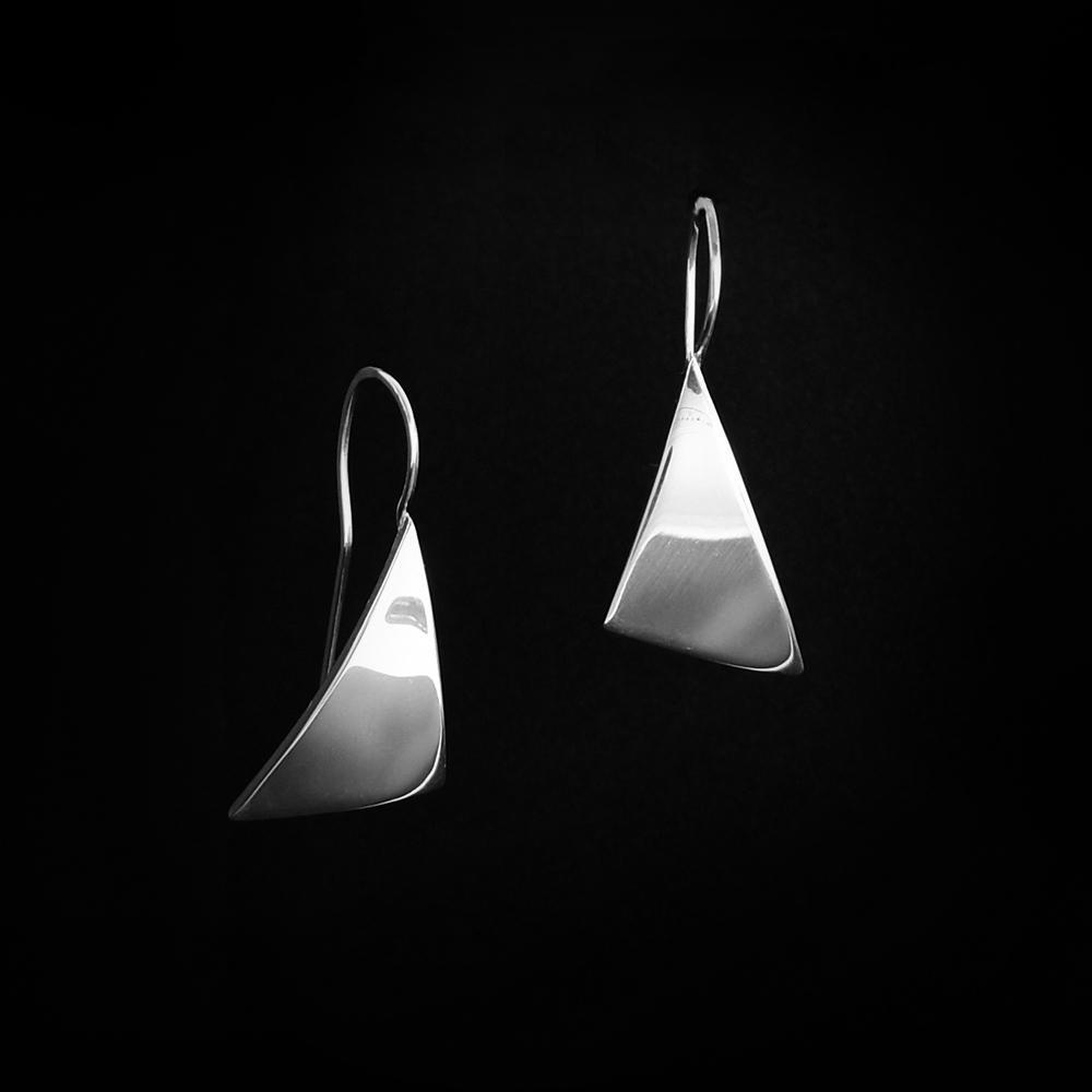 These sterling silver hanging earrings have soft, triangular hangs that resemble the sail of a sail boat.