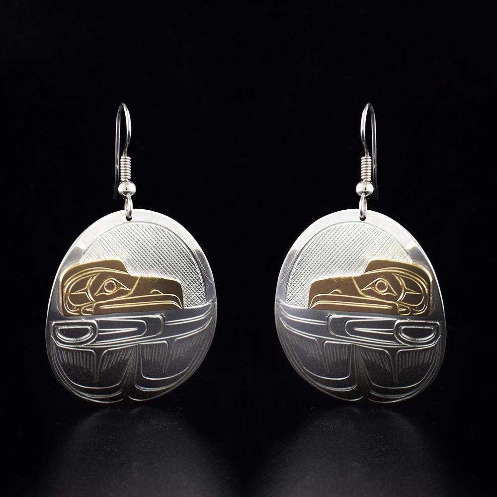 These sterling silver hook dangle Raven earrings are oval in shape, they depict the face and the wing of the Raven.
