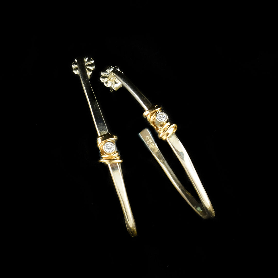 Wavy Coil with Cubic Zirconia Hoop Earrings by Joy Annett. Gold-filled accents in the center encasing the cubic zirconia with the rest of the earrings being sterling silver.