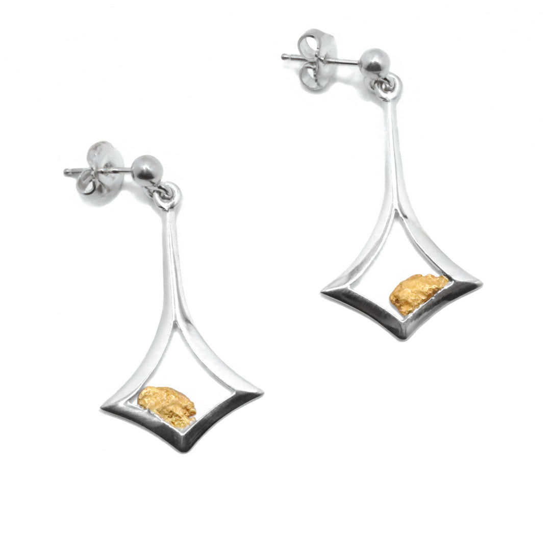 22K Gold Nugget Abstract Stud Earrings by Tom Gregorczyk. Each earring has been handcrafted in an abstract shape. The shape resembles a diamond that has been slightly bent with a long line connecting the bottom to the top. The artist has included 22k gold nuggets off-center at the bottom of the diamond shape in each earring. The background behind each nugget has been cut out.