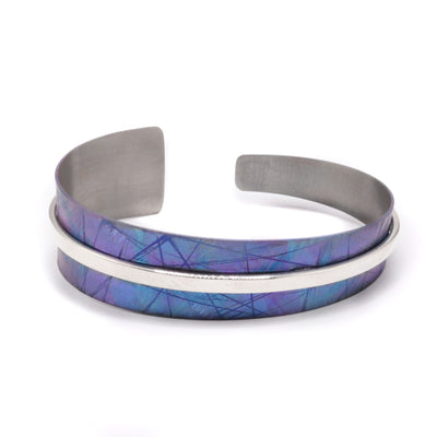 Asymmetric Blue Titanium Bracelet by Jean-Yves Nantel. Anodized blue titanium with a sterling silver accent in the middle. Bracelet tapers off from one side to the other creating an asymmetrical look.