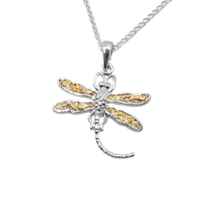 22K Gold Nugget Dragonfly Pendant by Tom Gregorczyk. The pendant is in the shape of a dragonfly with its wing spread out and a long tail. The artist has put 22k gold nuggets in the 4 wings of the dragonfly and made the rest of the piece using sterling silver.
