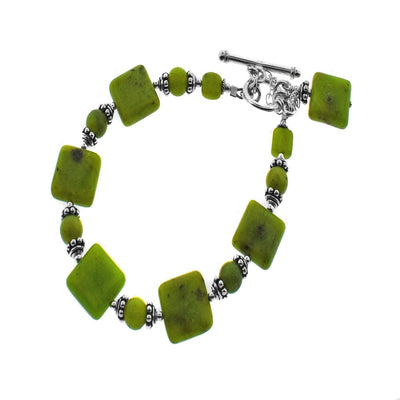 This Squares and Circles BC Jade Bracelet was made by artist Karley Smith. The pieces of BC Jade are separated by silver spacers.  The bracelet measures 6.5″ around when clasped shut. A safety chain adds an extra element of security to the silver toggle clasp.