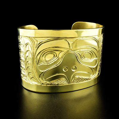 Brass 2" Horned Owl Bracelet by Paddy Seaweed. The design depicts the face of an owl looking straight forward in the middle of the bracelet. Both of the sides have been hand carved with delicate feathers.