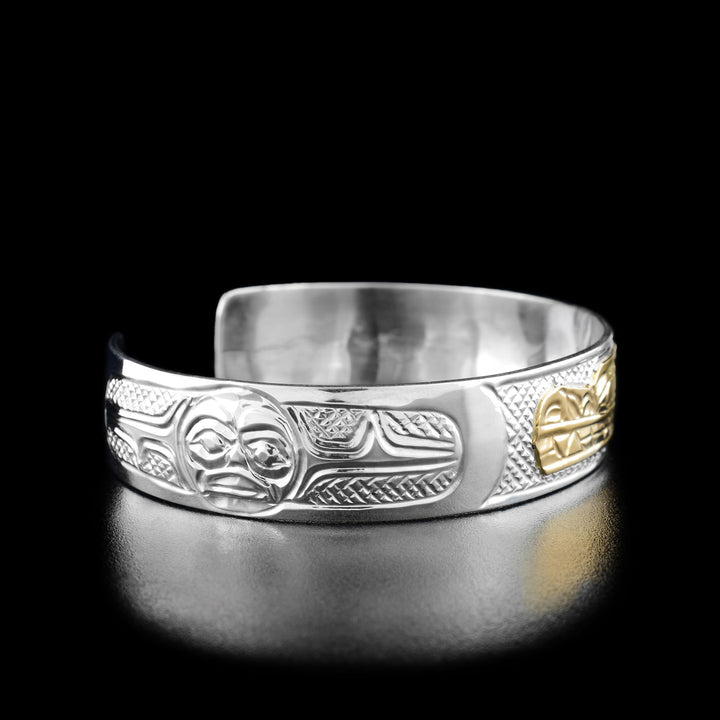 Left angle photo of the wolf bracelet shows the moon looking forward. Background is crosshatched.