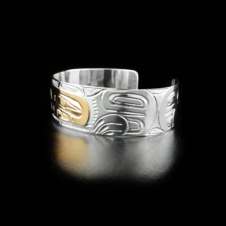 Right angle photo of the bracelet shows carved designs representing the full body and paws of the bear.