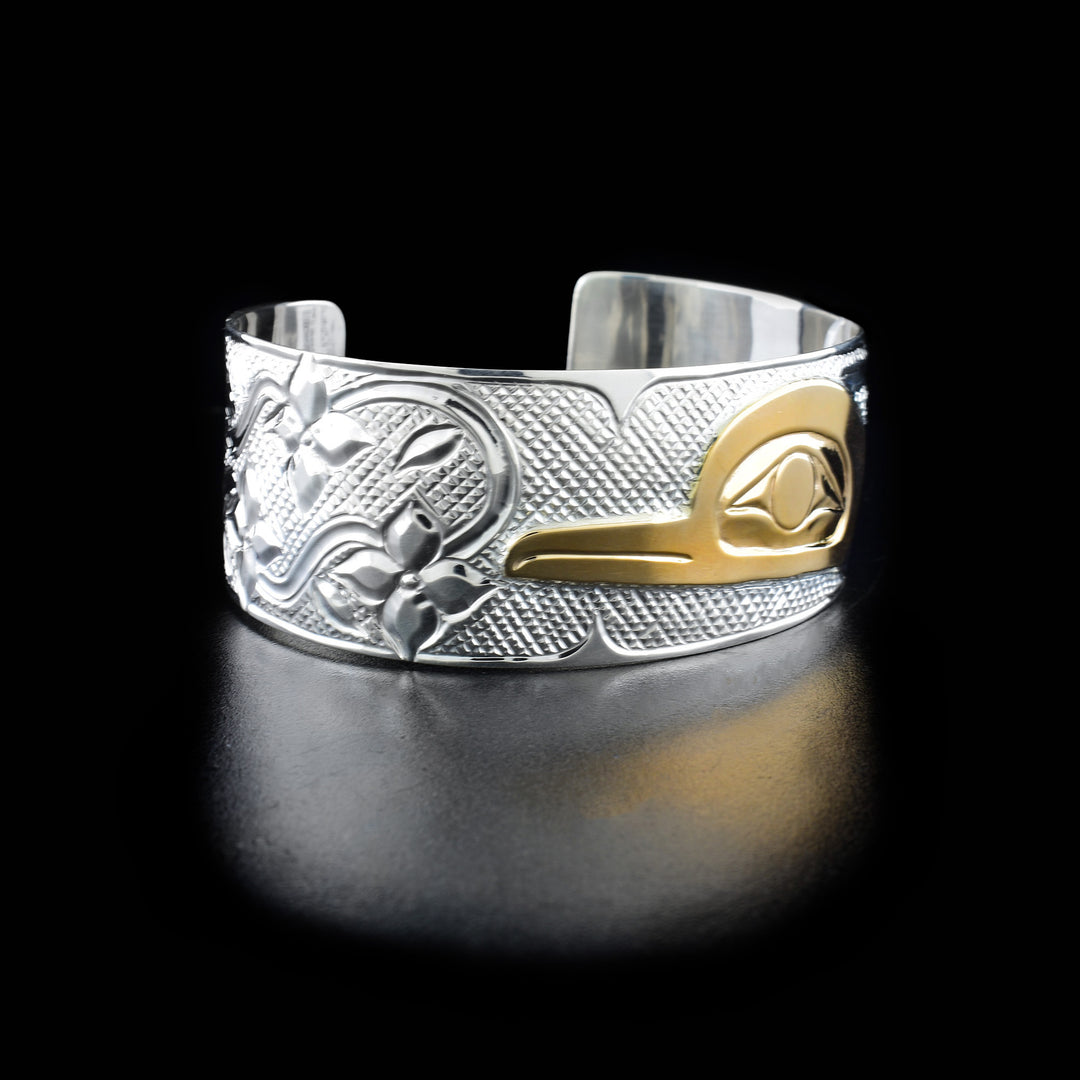 Left angle photo of the bracelet shows carved designs representing multiple flowers and leaves.