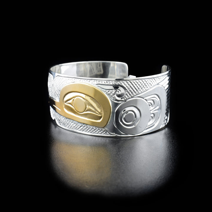 Right angle photo of the bracelet shows carved designs representing the body and spread wings of the hummingbird.